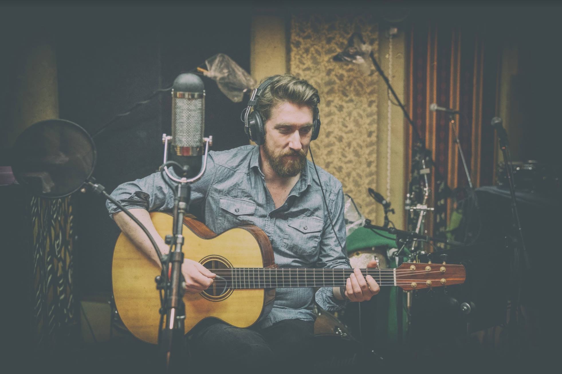 Brandon Bernstein in the studio with an acoustic guitar